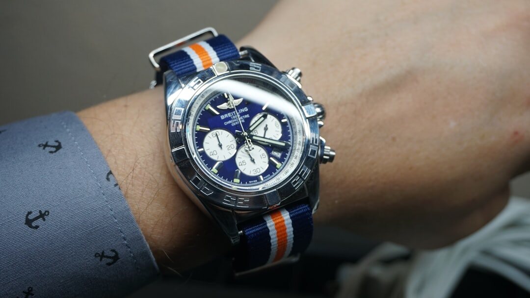 Elegant wristwatch with leather strap on a business shirt cuff