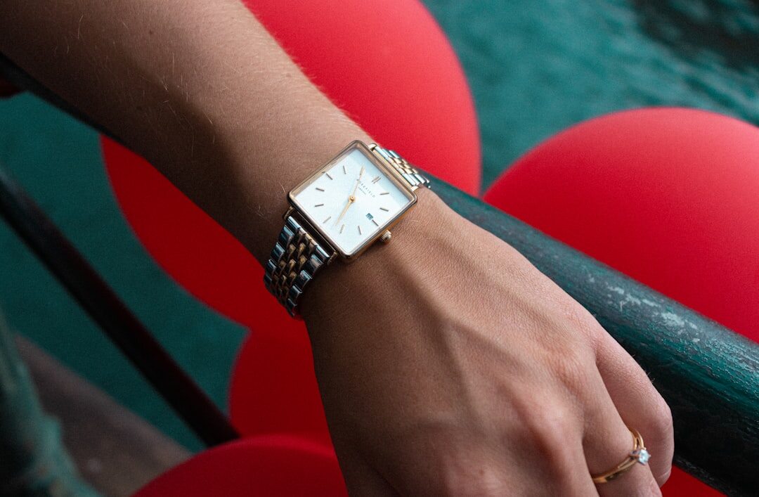 Elegant woman's wrist wearing a gold jewelry watch