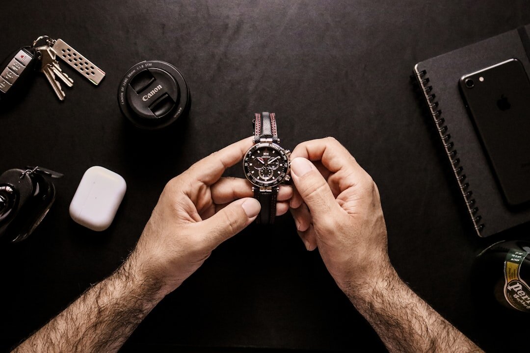 Elegant hands adjusting the strap of a luxury wristwatch