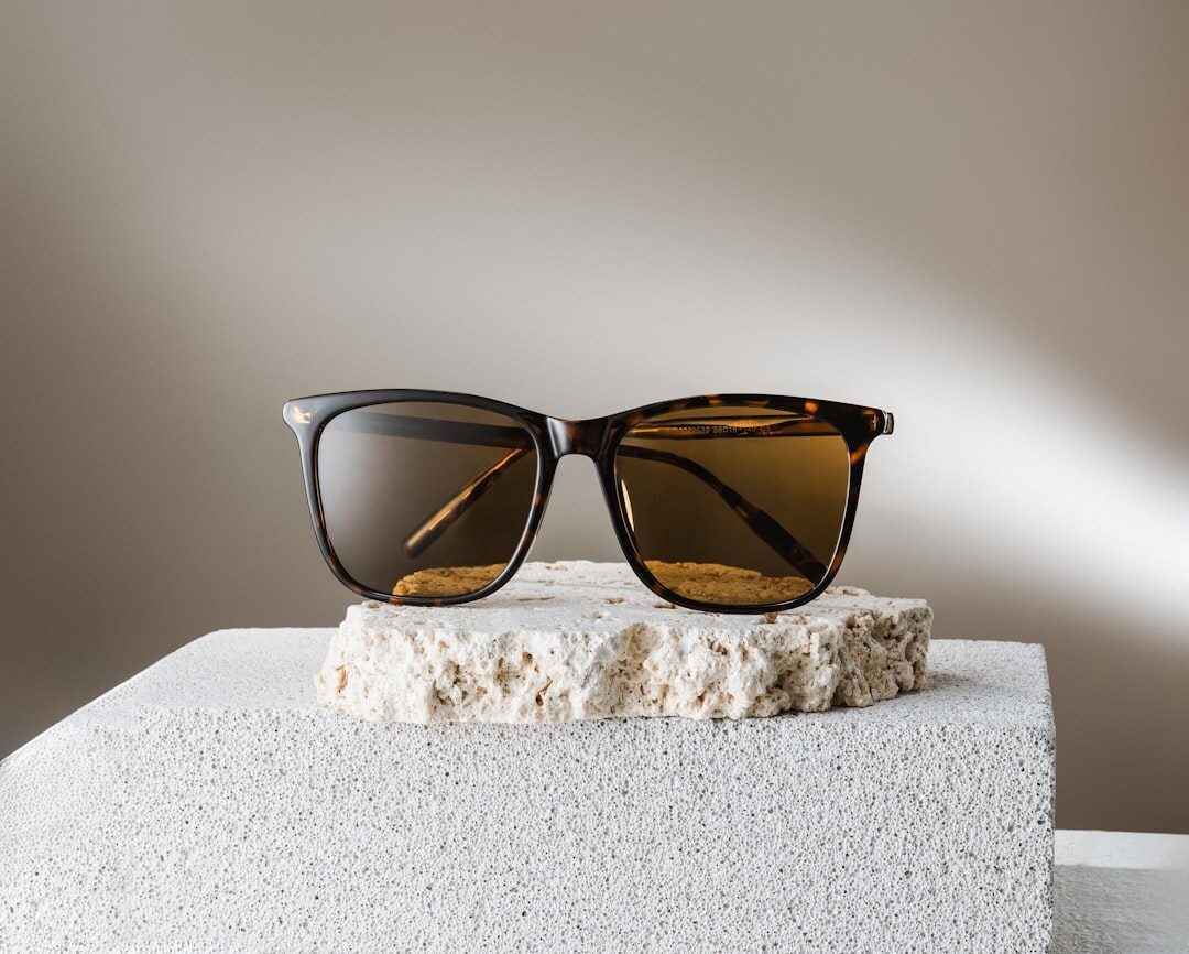 Designer sunglasses arranged on a neutral surface