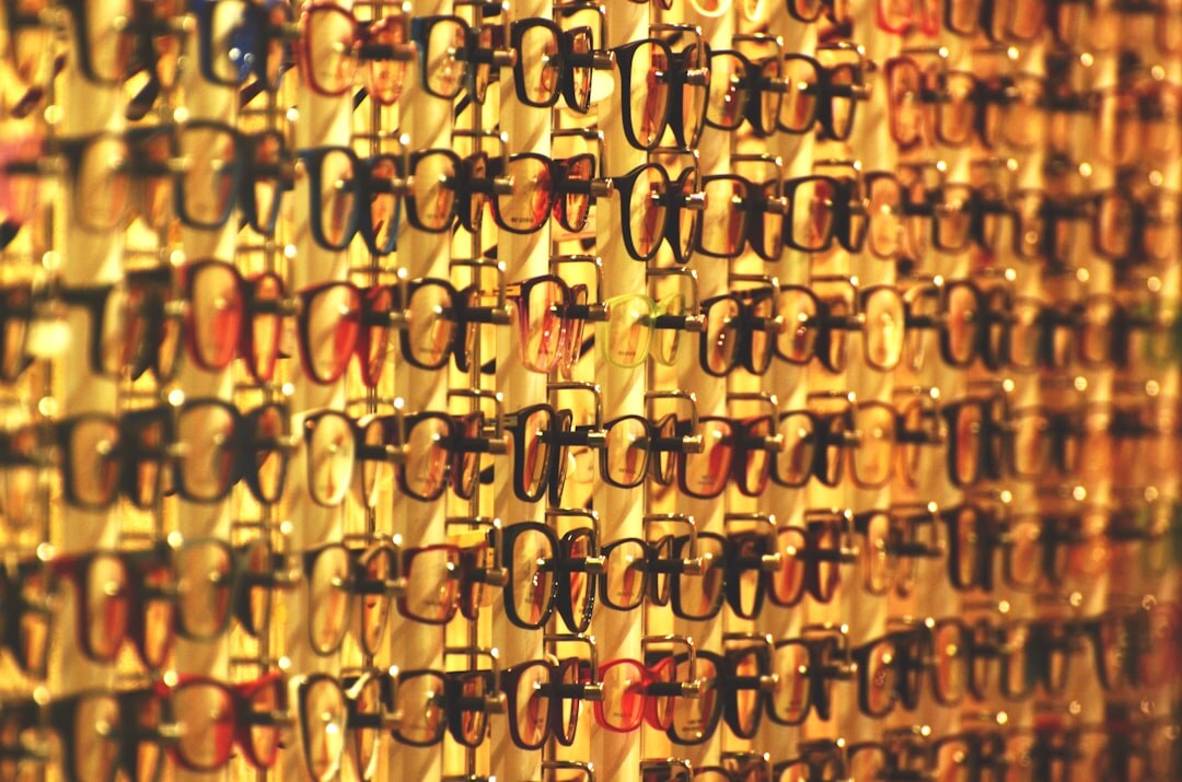 Luxury optical eyeglasses displayed on a wooden stand