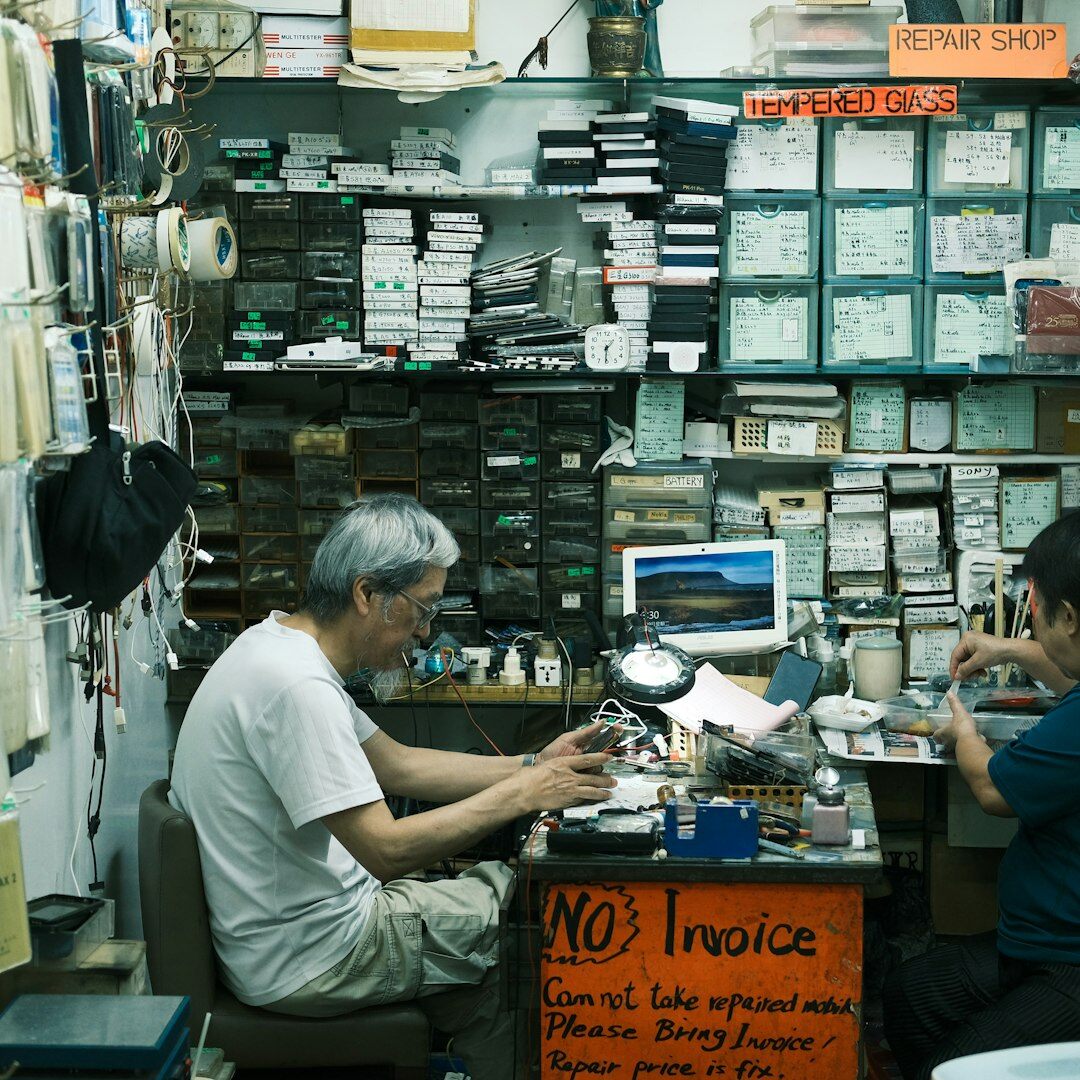 Artisan watchmaker's hands assembling a mechanical watch at a workbench